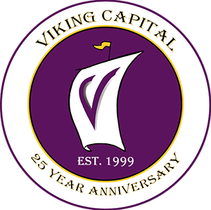 A purple and white logo for the viking capital.