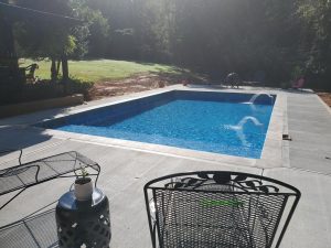 A pool with a table and chairs in the middle of it