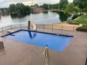 A pool with a slide and a ramp on the side of it