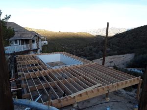 A building under construction with the roof being built.