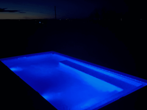 A pool with blue lights in the middle of it.