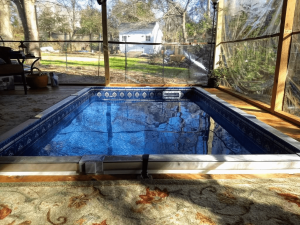 A pool that is in the middle of some grass.