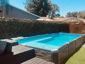 A pool that is in the middle of some grass.