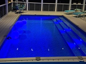 A pool with lights on the side of it