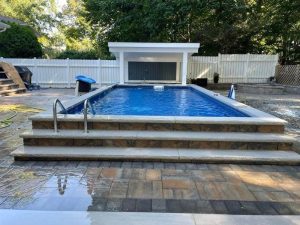 A pool with steps leading to the side of it.