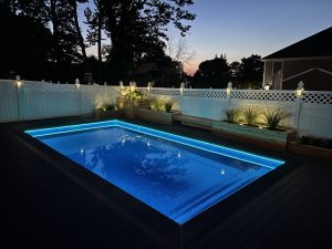 A pool with lights on the side of it