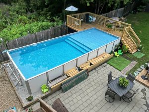 A pool that is in the middle of some grass.