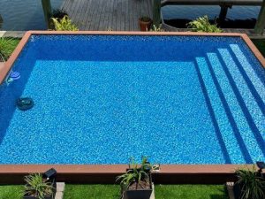 A pool with steps leading to the water.